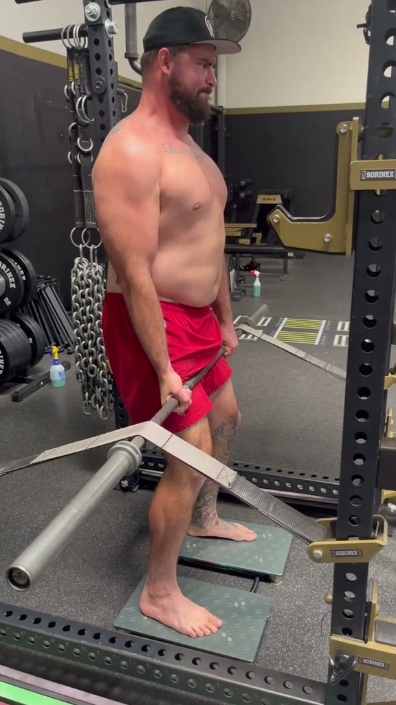 Real client Sean H. performing an isometric mid-thigh pull test on ForceDecks force plates, which measured 13 percent left-right asymmetry